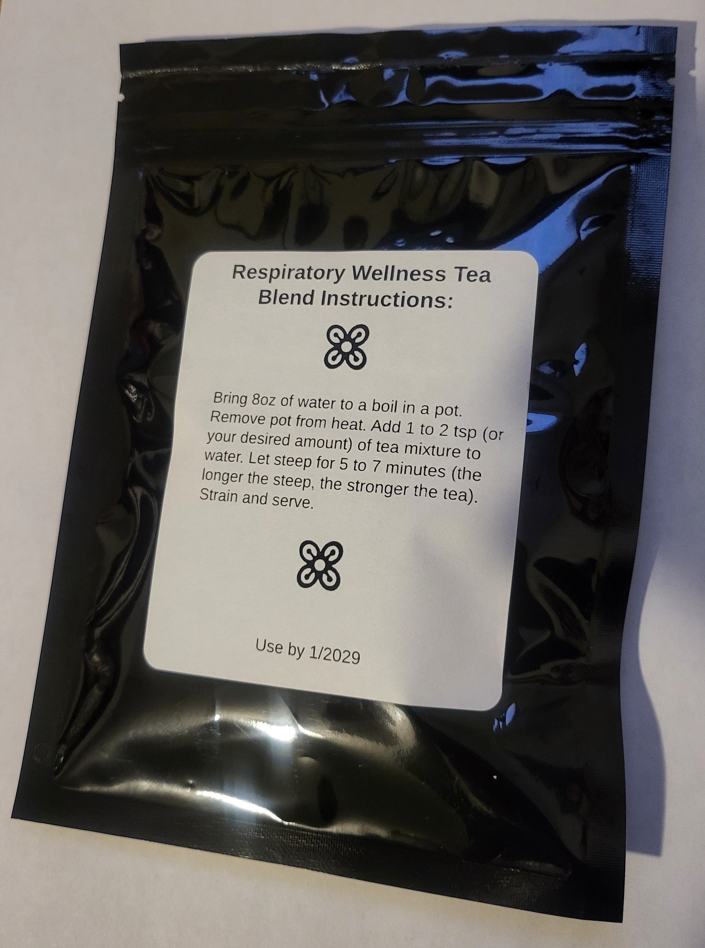 Loose herbal tea blend in a jar labeled Queen Tee's Premium Respiratory Wellness Tea by Queen Tee's Herbal Teas and Tinctures