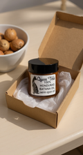 Premium Honduras Batana Oil from Queen Tee's Herbal Teas and Tinctures, shown in a glass jar for skin and hair care.