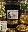 Loose chamomile tea leaves in a clear jar from Queen Tee's Herbal Teas and Tinctures, showcasing fresh, dried chamomile flowers.