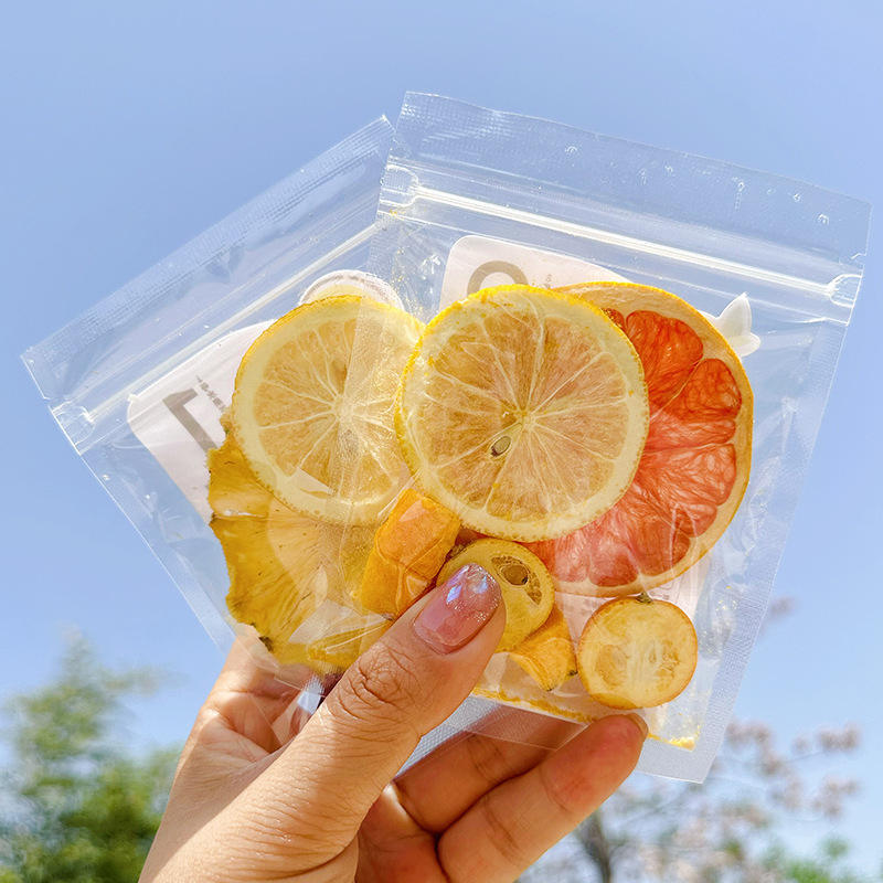 Queen Tee's Premium Freeze-Dried Fruit Tea Slices in loose tea packages, vibrant dried fruit slices for herbal tea blends