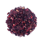 Loose leaf Hibiscus tea by Queen Tee’s Herbal Teas and Tinctures, vibrant red dried hibiscus flowers in a clear jar.
