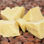 Queen Tees 100% pure African cocoa butter in a bulk container, showing smooth, creamy texture ideal for skincare or culinary use.