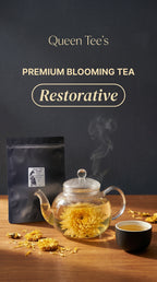 Loose Queen Tee's Premium Golden Chrysanthemum Blooming Tea with blooming chrysanthemum flowers in a clear glass teapot.