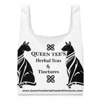 Black Queen Tee's Herbal Teas and Tinctures shopping bag with all-over herbal print, durable fabric, and sturdy handles.