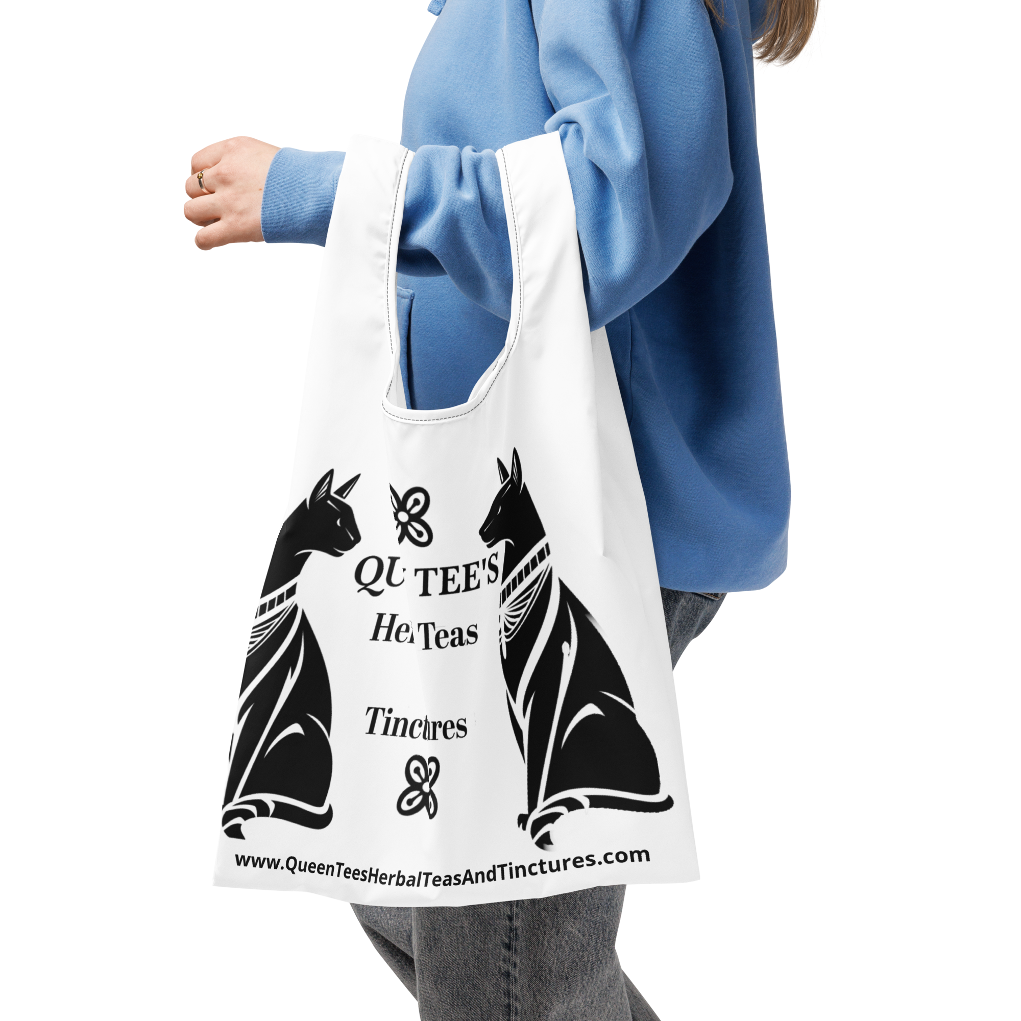 Queen Tee's Herbal Teas and Tinctures shopping bag with all-over herbal print, black background, reusable accessory for tea lovers.