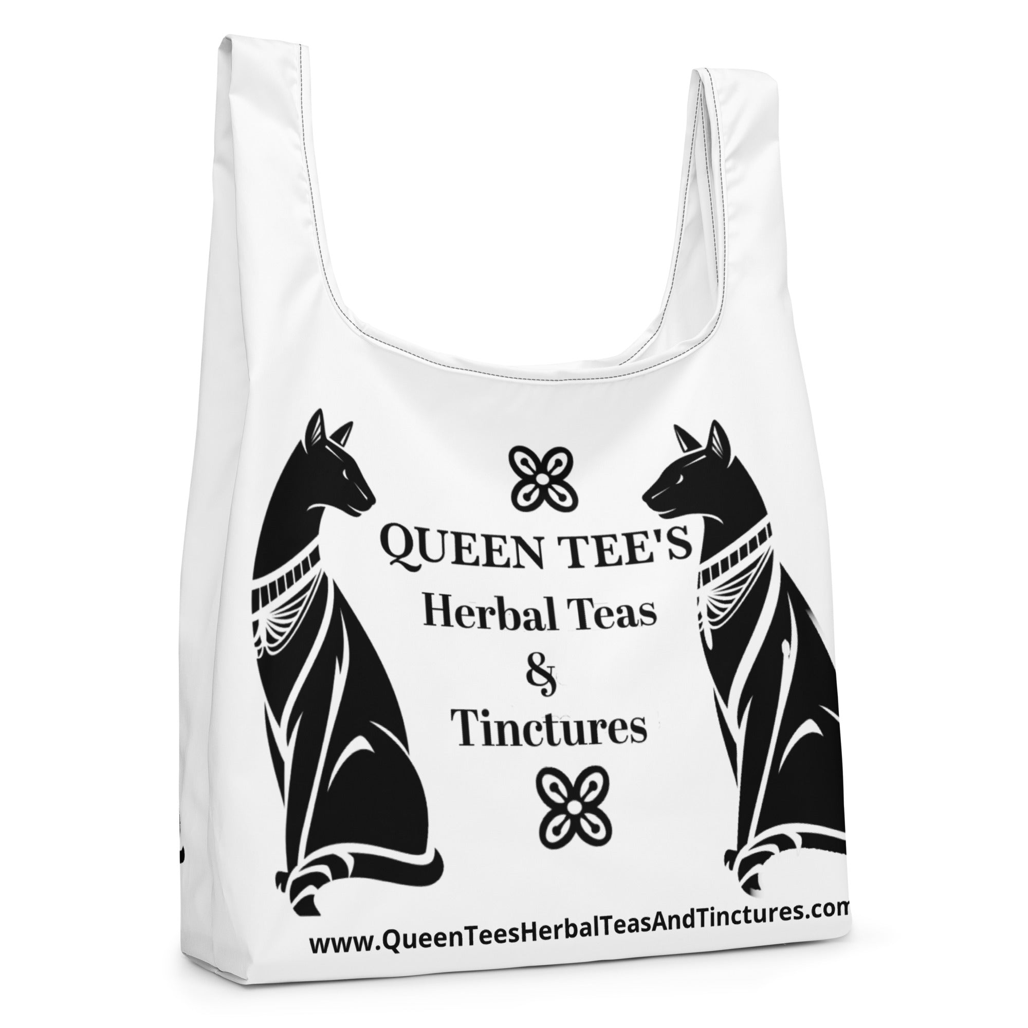 Queen Tee's Herbal Teas and Tinctures shopping bag, black all-over print, with handles and brand logo, durable accessory for herbal product shopping.