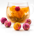 Queen Tee's Organic Dried Rose Blooming Tea Ball showing a natural herbal loose tea with blooming rose flowers and tea bombs.