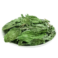 Loose leaf peppermint herbal tea from Queen Tee's, showing vibrant green peppermint tea leaves.
